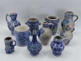 many blue and white vases sitting on a white surface