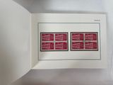 an open book with a picture of two stamps on it