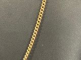 a gold necklace with a chain that is attached to a mannequin mannequin mannequin mann