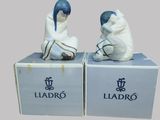 pair of ceramic figurines of a man and a woman sitting on a box