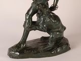 bronze statue of a man with a goat on a white background