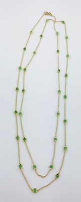 gros plan d'un collier de perles vertes sur fond blanc