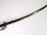 a picture of a sword that is on a white surface