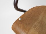 a close up of a wooden chair with a metal handle