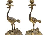 pair of brass candlesticks with birds on top of a rock