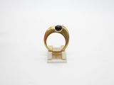 a gold ring with a black stone on it