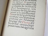an open book with writing on it sitting on a table