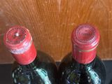 two bottles of wine that are sitting on a table