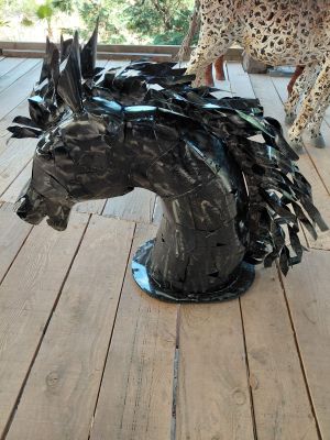 a sculpture of a horse and a cheetah on a porch