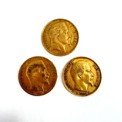 three gold coins with a picture of a man and a woman on them