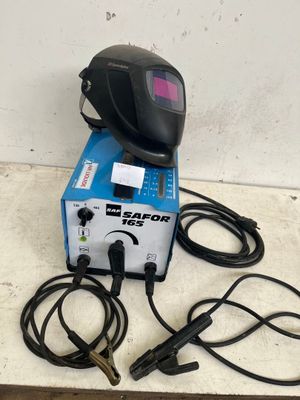 a welding machine sitting on top of a table next to some wires