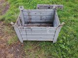 a metal box sitting in the grass on the ground