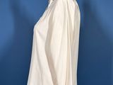 white shirt on a mannequin stand against a blue wall