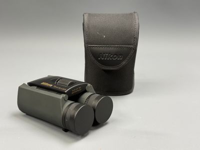 a close up of a camera and a case on a white surface