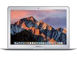 an apple macbook air laptop computer with a mountain range in the background