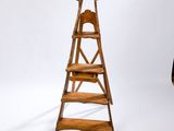 a wooden ladder that is standing up against a white backdrop