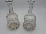 pair of crystal decanters with stoppers on each side