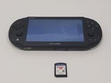 a small black game console with a memory card next to it
