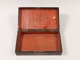 an old wooden box is open on a white surface