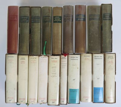 several old books are stacked on top of each other on a table