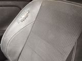 a close up of a car seat with a sunburst on it