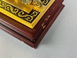 a gold and black clock sitting on a table
