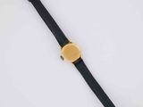 a close up of a watch on a white surface