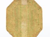a green and gold bag with a handle on a white surface