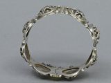a close up of a silver ring on a gray surface