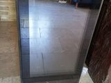 a black oven sitting in the middle of a tiled floor