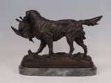 statue of a dog with a bird in its mouth on a marble base