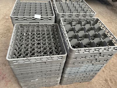 several plastic containers are stacked on top of each other on the ground