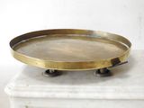 an antique brass tray on top of a marble table