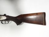 an old rifle with a wooden handle and a silver plate on it