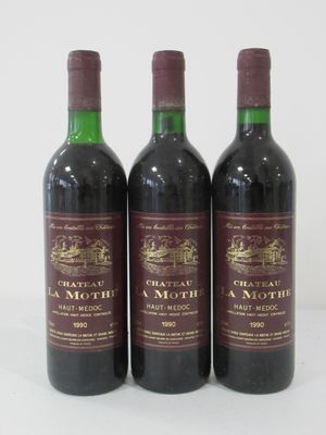 three bottles of red wine sitting next to each other on a white surface