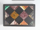 a black tray with a colorful tile design on it