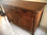 a wooden cabinet that is sitting on a tile floor