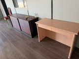 a desk with a mirror and a chair in a room
