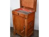 an old wooden chest with a drawer on top of it