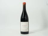 the bottle of red wine is sitting on the table