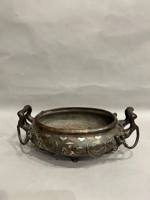 an old bronze bowl with handles and handles on a white background