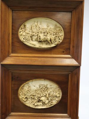 paire de plaques anciennes en bois sculpté représentant une scène de bataille