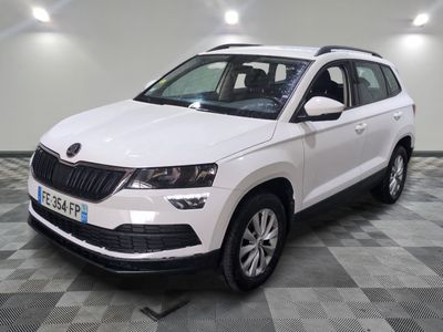 the white skoda is parked on a checkered tile floor
