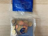 a bag of coins sitting on top of a wooden table