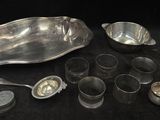 a lot of silver spoons and bowls on the table