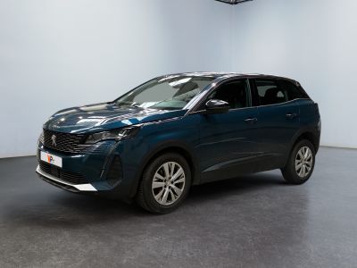 La voiture bleue est garée dans une pièce blanche au sol noir.