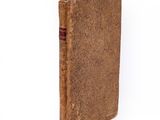 un vieux livre posé sur une surface blanche, sur fond blanc