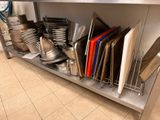 many pans and pans on the shelf in the kitchen