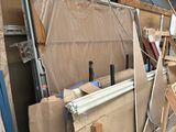 many pieces of furniture that are stacked up in a warehouse