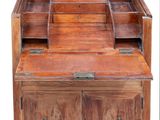 a wooden desk with a mirror on top of it